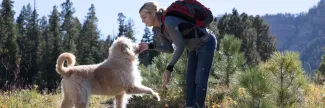 Image of a dog jumping on a woman outside the front door
